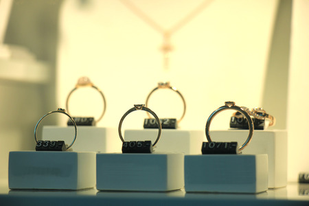 Diamond engagement rings and other jewelry in a jeweler shop displayの写真素材