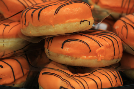 Orange iced donuts to celebrate King's Day on April 27th. Orange is the national color in the Netherlandsの写真素材