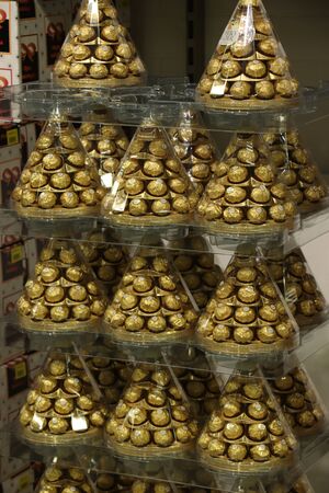 Beverwijk, the Netherlands, october 26th 2018:  Ferrero Rocher Christmas gift boxes. The Ferrero Rocher praline is a chocolate and hazelnut confectionery produced by the Italian chocolatier Ferreroのeditorial素材