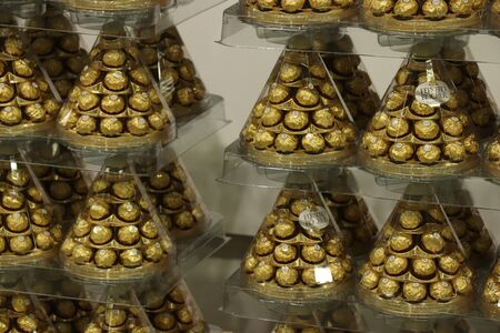 Beverwijk, the Netherlands, october 26th 2018:  Ferrero Rocher Christmas gift boxes. The Ferrero Rocher praline is a chocolate and hazelnut confectionery produced by the Italian chocolatier Ferreroのeditorial素材