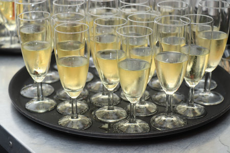 Glasses of champagne on a tray, served on a wedding reception