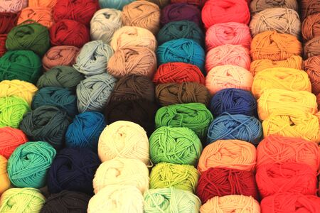 Multi-colored wool yarns arranged in colors in a shopの写真素材