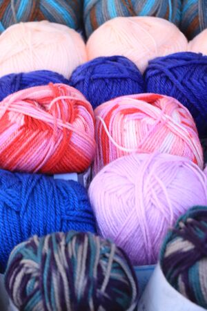 Multi-colored wool yarns arranged in colors in a shop