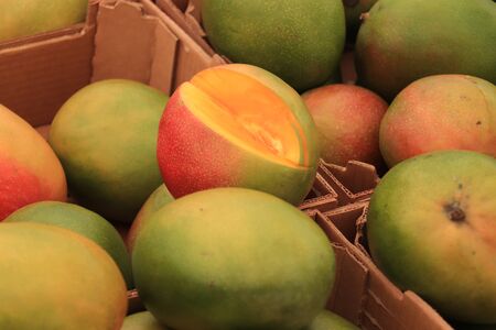 Fresh fruit on a market stalll,big ripe mangosの写真素材