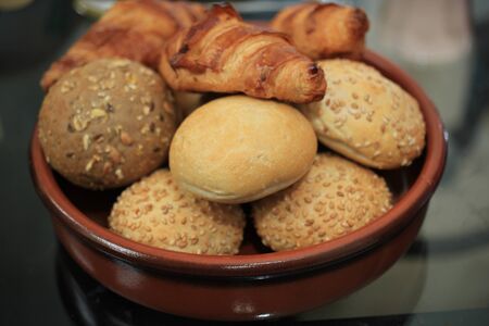 Assortment of fresh mini sized or bite-size bread on the breakfast table