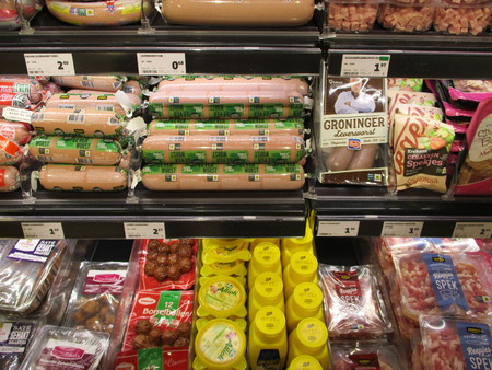 Gieten, The Netherlands - July 28th, 2019:  Different sorts of packaged sausages and cold cuts in a supermarket fridge. Text on tags: product information in Dutch, prices in Euro.のeditorial素材