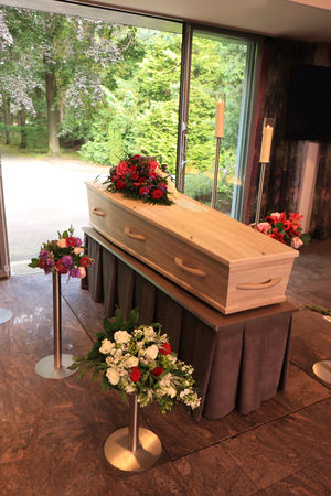 A coffin with a flower arrangement in a morgue, a funeral serviceのeditorial素材