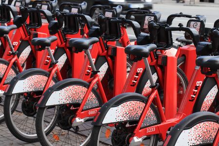 Barcelona, Spain - september 28th, 2019: Red rental bicycles, parked in the city centre of...