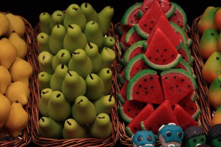 Marzipan fruits in all colors and flavours displayed at Boqueria market in Barcelonaの写真素材