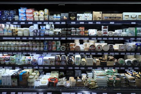 Barcelona, Spain - september 30th 2019: Cheese in a luxurious supermarket. Fridge filled with various sorts of prepacked cheese, food department El Corte Inglesのeditorial素材