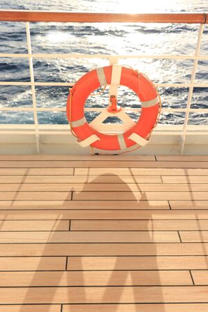 Orange lifebuoy on the railing of a cruise ship