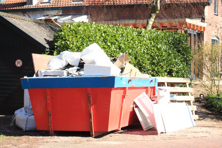 Loaded dumpster near a construction site or home renovation