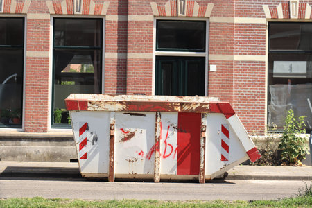 Loaded dumpster near a construction site or home renovation