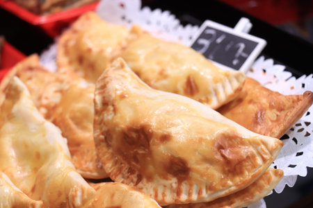 Barcelona, Spain - September 30th 2019: Traditional empanadas at a market. An empanada is a fried...