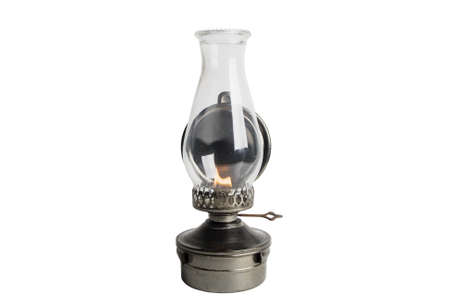 Lit Antique oil lamp isolated on whiteの写真素材