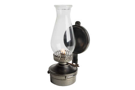 Lit Antique oil lamp isolated on whiteの写真素材