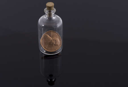 One penny in corked bottle の写真素材