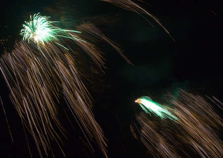 long exposure of multiple fireworks against a black background の写真素材