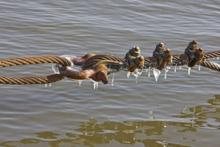 Ice encrusted ship tie linesの写真素材