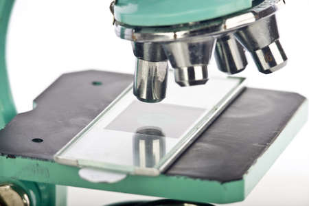 Close up of microscope and Slide on White Backgroundの写真素材
