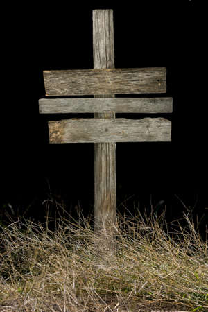 Vintage road sign at night isolated on a black background の写真素材