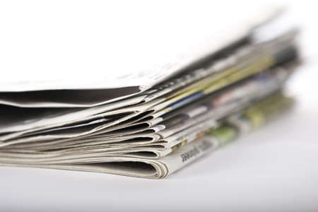 Pile of old newspapers isolated on a white background の写真素材
