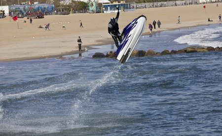 Man on jet ski jump on the wave