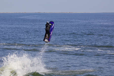 Man on jet ski jump on the waveの写真素材