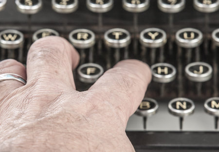 Vintage portable typewriter with fingers