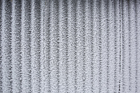 Snow blown on metal wall abstract background 