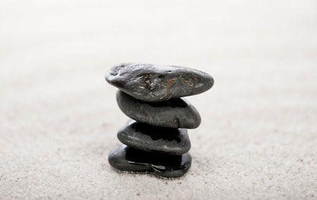 Stacked stones on sand in a Japanese ornamental or zen garden の写真素材