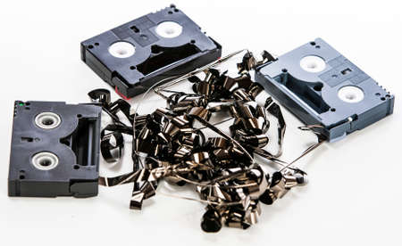 Broken video tapes in a pile on whiteの写真素材