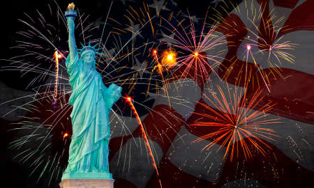 Colorful fireworks on black sky with statue of libertyの写真素材