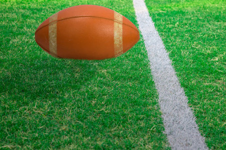 White stripe and football on green football field