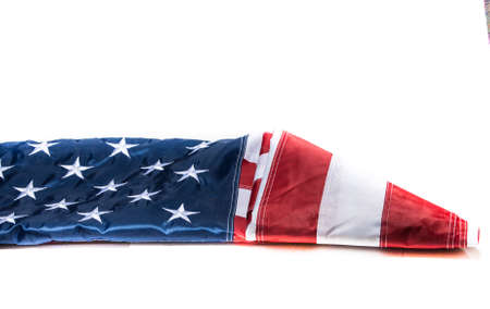 American Flag being folded with white backgroundの写真素材