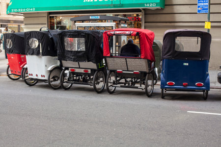 NEW YORK - January 9: Pedal taxis waiting for fares by central park New York city, January 9, 2011. It is another of many ways to get around New york city with pedal power.のeditorial素材
