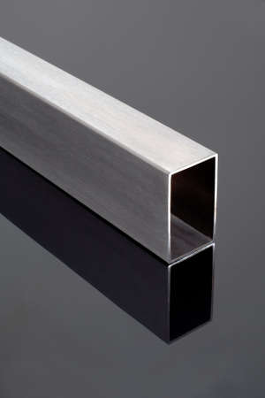 stainless steel square pipe, on a black glossy surfaceの写真素材