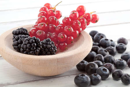currants, blackberries and blueberries in a rustich style picture, high key の写真素材
