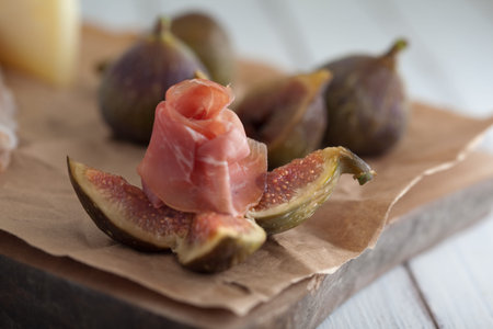 fig and ham on a white rustic tableの写真素材