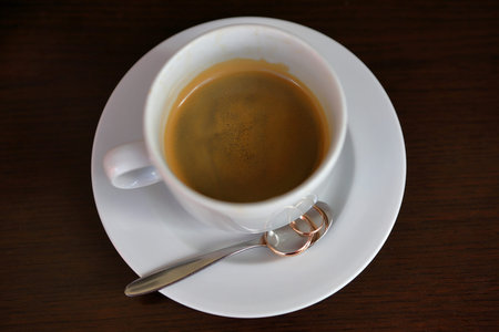 Composition of wedding rings with the cup of coffee