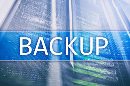 Backup button on modern server room background. Data loss prevention. System recovery. の写真素材