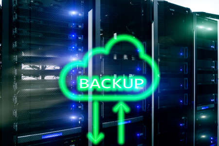 Backup button on modern server room background. Data loss prevention. System recovery.の写真素材