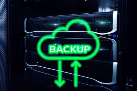 Backup button on modern server room background. Data loss prevention. System recovery.の写真素材