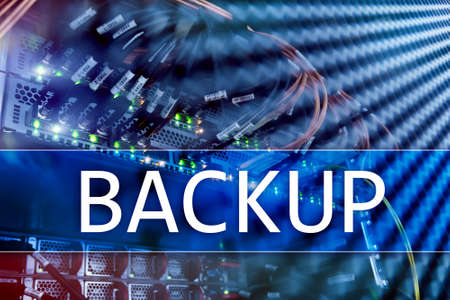 Backup button on modern server room background. Data loss prevention. System recovery.の写真素材