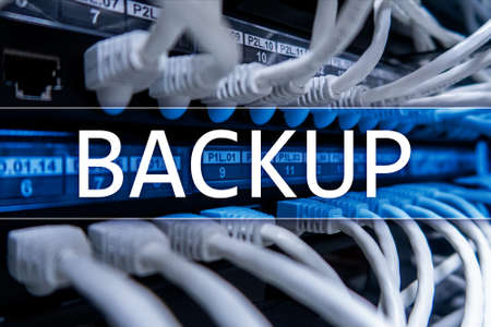 Backup button on modern server room background. Data loss prevention. System recovery.の写真素材