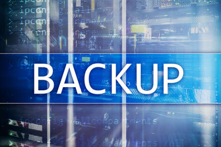 Backup button on modern server room background. Data loss prevention. System recovery.の写真素材