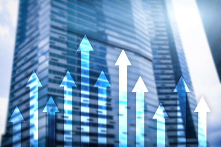 Up arrow graph on skyscraper background. Invesment and financial growth concept.の写真素材