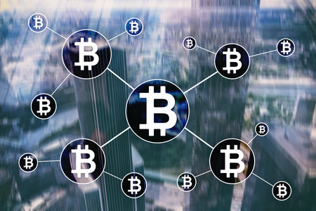 Bitcoin cryptocurrency and blockchain technology concept on blurred skyscrapers background.