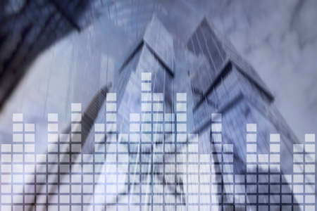 Financial chart on blurred skyscraper office background.の写真素材