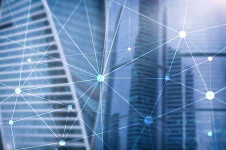 Blockchain network on blurred skyscrapers background. Financial technology and communication concept.の写真素材